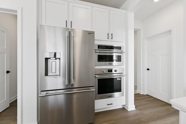 9863 49th St NE, Saint Michael, MN 55376 - kitchen featuring appliances with stainless steel finishes, dark wood finished floors, white cabinetry, and light countertops