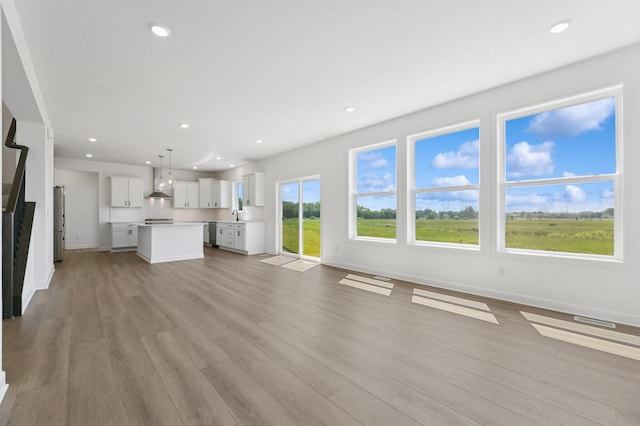 9863 49th St NE, Saint Michael, MN 55376 - unfurnished living room with light wood-style floors and recessed lighting