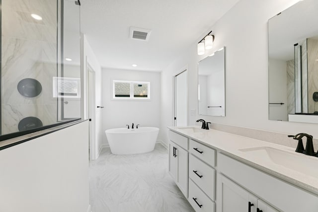 9863 49th St NE, Saint Michael, MN 55376 - full bathroom featuring a shower stall, double vanity, marble finish flooring, a freestanding bath, and recessed lighting