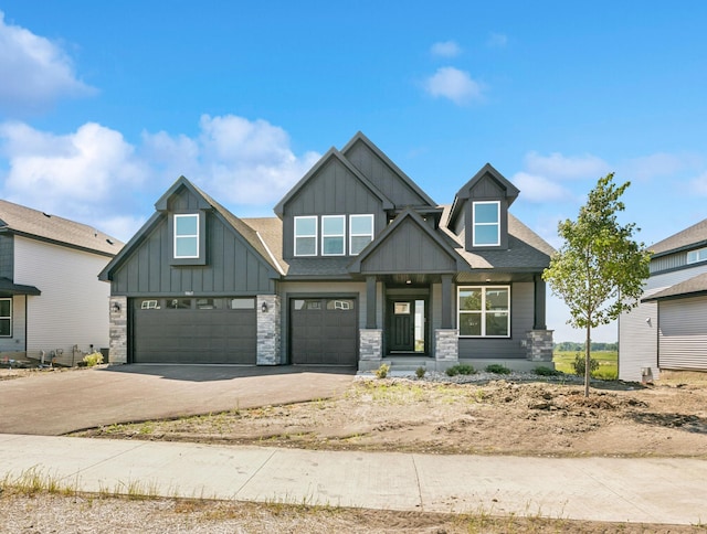 9863 49th St NE, Saint Michael, MN 55376 - craftsman inspired home with board and batten siding, stone siding, driveway, a garage, and a shingled roof