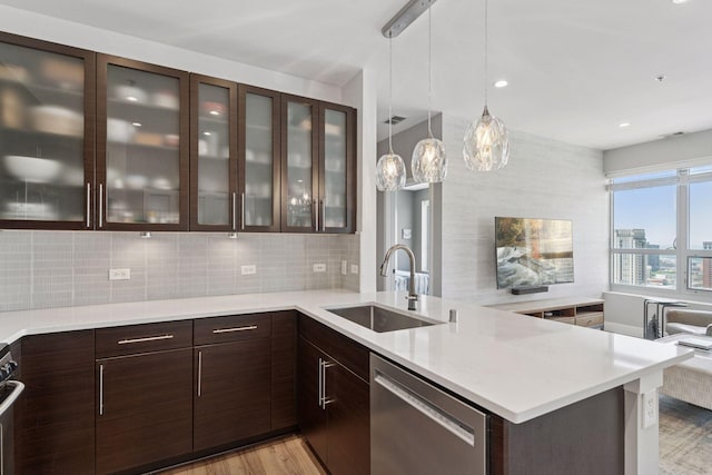 929 Portland Ave Unit 2510, Minneapolis, MN 55404 - kitchen featuring dishwasher, dark brown cabinetry, light wood finished floors, decorative backsplash, and a peninsula