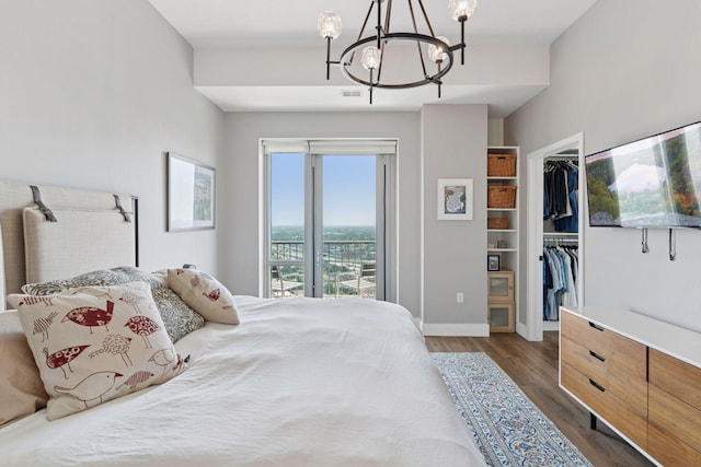 929 Portland Ave Unit 2510, Minneapolis, MN 55404 - bedroom with a chandelier, dark wood-style floors, a walk in closet, and access to outside