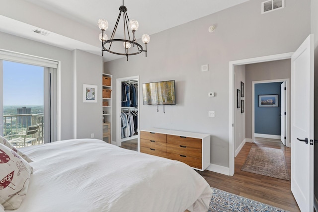 929 Portland Ave Unit 2510, Minneapolis, MN 55404 - bedroom featuring a chandelier, wood finished floors, a walk in closet, and access to outside