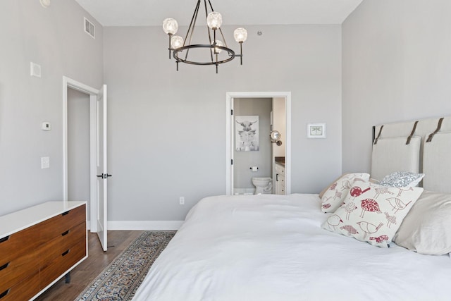 929 Portland Ave Unit 2510, Minneapolis, MN 55404 - bedroom featuring a chandelier, dark wood-style floors, and connected bathroom