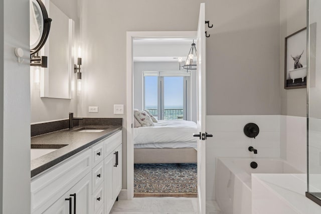 929 Portland Ave Unit 2510, Minneapolis, MN 55404 - bathroom featuring double vanity, a bath, a chandelier, and connected bathroom