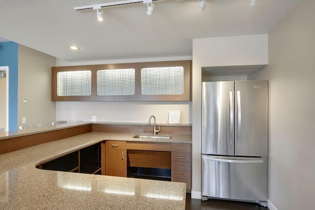 929 Portland Ave Unit 2510, Minneapolis, MN 55404 - kitchen featuring freestanding refrigerator, brown cabinetry, track lighting, light stone countertops, and recessed lighting