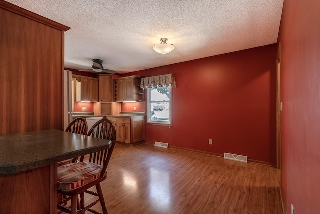 315 Pierce Ave, North Mankato, MN 56003 - dining area featuring wood finished floors, ceiling fan, and a textured ceiling