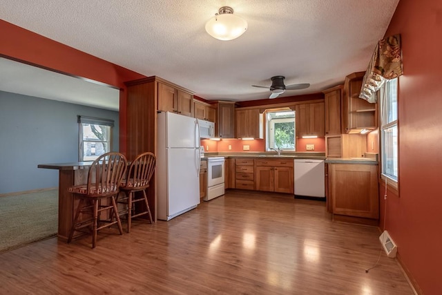 315 Pierce Ave, North Mankato, MN 56003 - kitchen featuring white appliances, ceiling fan, wood finished floors, open shelves, and a textured ceiling