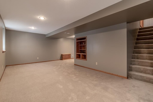 315 Pierce Ave, North Mankato, MN 56003 - finished basement featuring light colored carpet, stairs, built in features, and recessed lighting