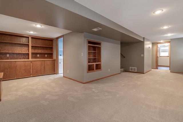 315 Pierce Ave, North Mankato, MN 56003 - below grade area featuring carpet flooring, built in features, stairway, and recessed lighting