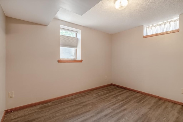 315 Pierce Ave, North Mankato, MN 56003 - below grade area featuring wood finished floors and a textured ceiling