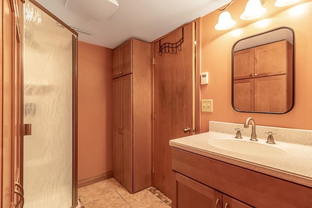 315 Pierce Ave, North Mankato, MN 56003 - bathroom with a shower stall, vanity, and tile patterned flooring