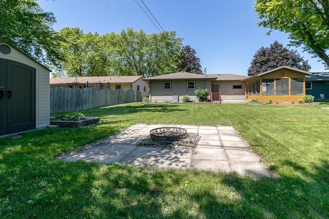315 Pierce Ave, North Mankato, MN 56003 - view of yard with a fire pit, a patio, a sunroom, and a storage unit