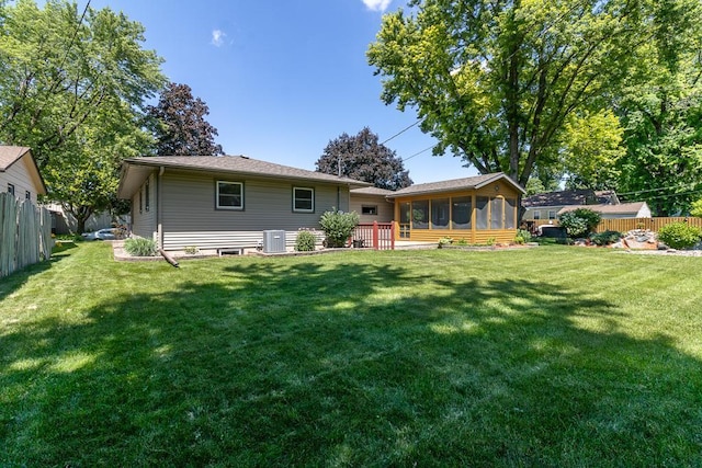 315 Pierce Ave, North Mankato, MN 56003 - rear view of house featuring a sunroom and a fenced backyard