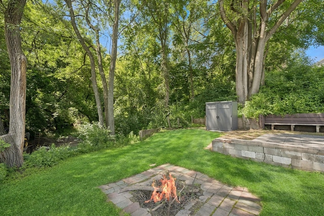 1818 1st St N, Stillwater, MN 55082 - view of green lawn featuring an outdoor fire pit and a storage shed