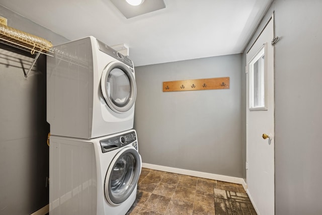 1818 1st St N, Stillwater, MN 55082 - laundry area featuring stacked washer / dryer and stone finish flooring