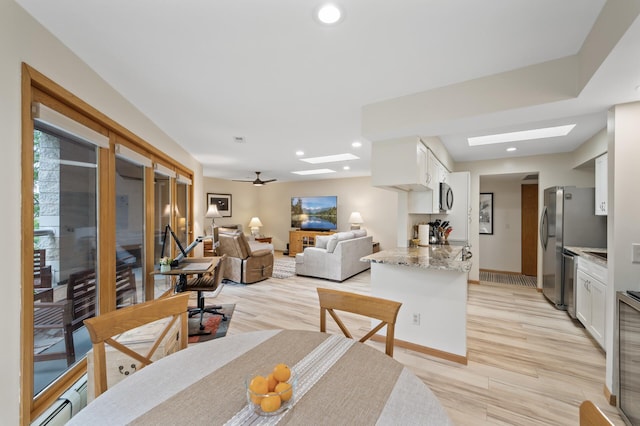 14575 Burma Ave W Unit 306, Rosemount, MN 55068 - dining area with a skylight, a baseboard heating unit, light wood-type flooring, and recessed lighting