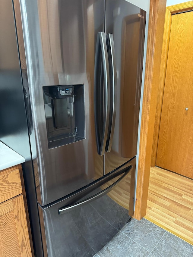 2518 Parkhill Ln SW, Rochester, MN 55902 - kitchen view of stainless steel fridge with ice dispenser, brown cabinetry, and light countertops