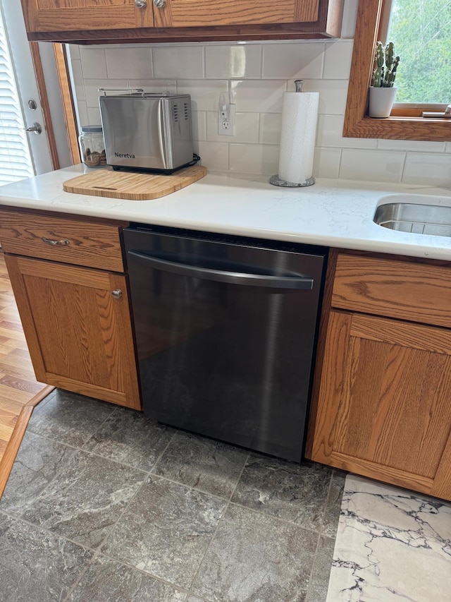 2518 Parkhill Ln SW, Rochester, MN 55902 - kitchen featuring dishwasher, brown cabinetry, backsplash, and light countertops