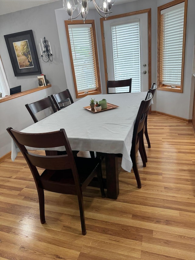 2518 Parkhill Ln SW, Rochester, MN 55902 - dining area with a chandelier and light wood-style flooring