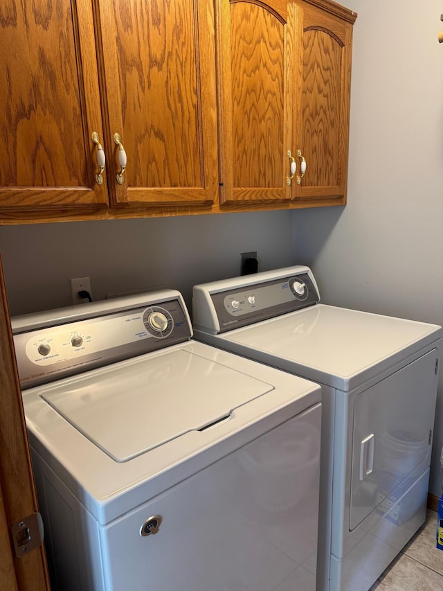 2518 Parkhill Ln SW, Rochester, MN 55902 - laundry room with cabinet space, washer and clothes dryer, and tile patterned flooring