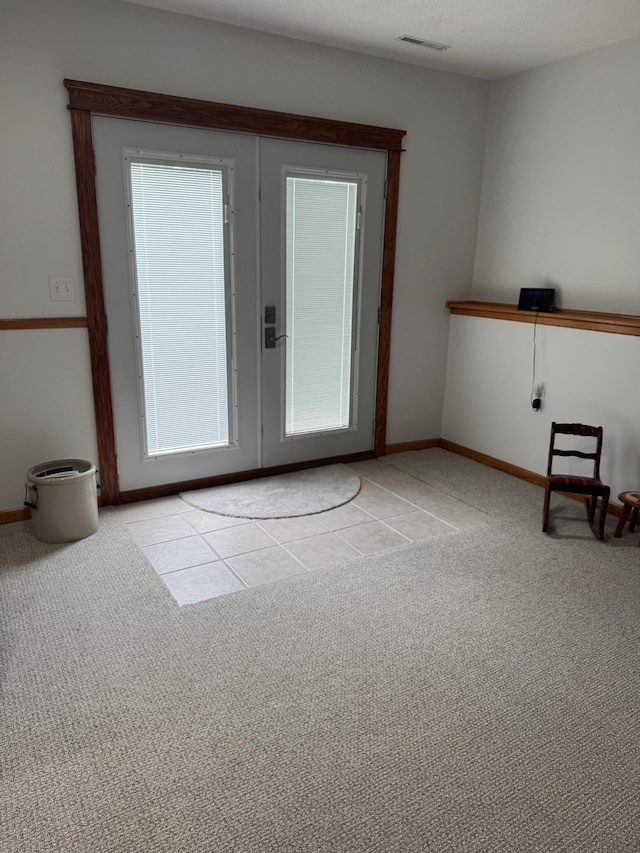2518 Parkhill Ln SW, Rochester, MN 55902 - doorway to outside with carpet flooring and tile patterned floors