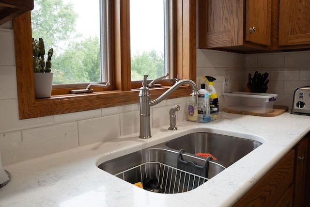 2518 Parkhill Ln SW, Rochester, MN 55902 - kitchen view of decorative backsplash, light countertops, and brown cabinets