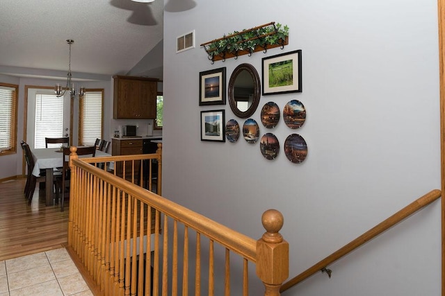 2518 Parkhill Ln SW, Rochester, MN 55902 - corridor featuring a chandelier, lofted ceiling, and light tile patterned floors