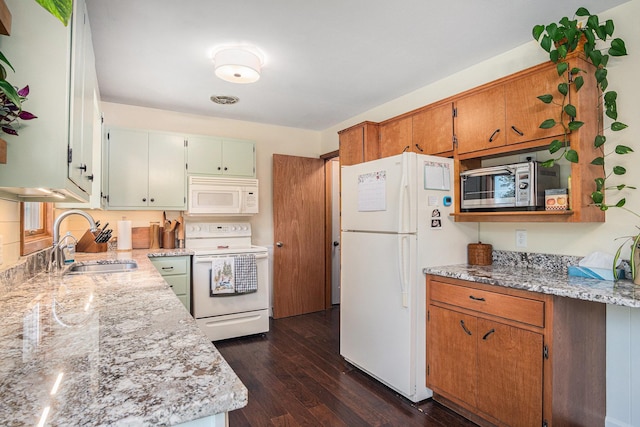 501 Central Ln, Luverne, MN 56156 - kitchen featuring white appliances, dark wood finished floors, and light stone countertops