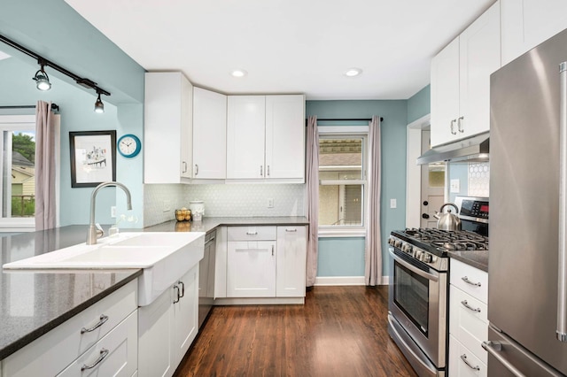 579 36th Ave NE, Minneapolis, MN 55418 - kitchen with stainless steel appliances, under cabinet range hood, backsplash, plenty of natural light, and recessed lighting
