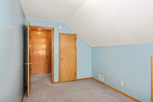 579 36th Ave NE, Minneapolis, MN 55418 - bonus room with a textured ceiling, lofted ceiling, and light colored carpet