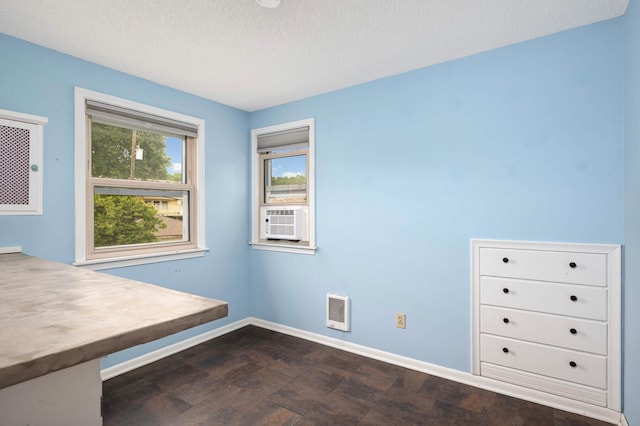 579 36th Ave NE, Minneapolis, MN 55418 - spare room with cooling unit, dark wood-type flooring, a textured ceiling, and heating unit