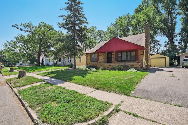 272 Butler Ave E, West Saint Paul, MN 55118 - view of front of property featuring brick siding, asphalt driveway, a chimney, a front lawn, and an outbuilding