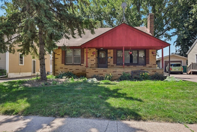272 Butler Ave E, West Saint Paul, MN 55118 - view of front facade featuring brick siding, a chimney, a front lawn, and an outdoor structure