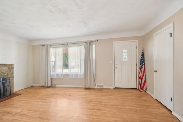 272 Butler Ave E, West Saint Paul, MN 55118 - foyer featuring healthy amount of natural light, light wood-style floors, and a fireplace with flush hearth