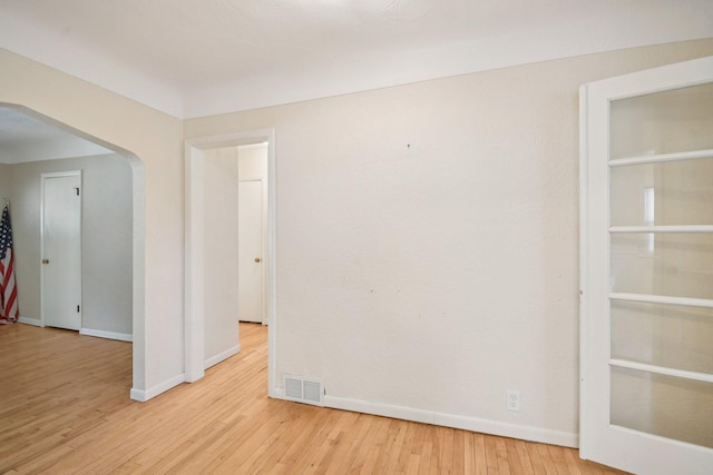 272 Butler Ave E, West Saint Paul, MN 55118 - spare room with wood finished floors and arched walkways