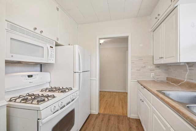 272 Butler Ave E, West Saint Paul, MN 55118 - kitchen featuring white appliances, white cabinetry, light wood-type flooring, decorative backsplash, and light countertops