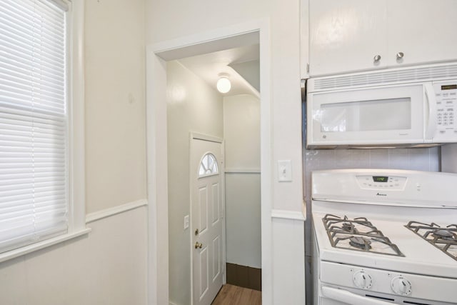 272 Butler Ave E, West Saint Paul, MN 55118 - kitchen with white appliances, tasteful backsplash, wood finished floors, and white cabinetry