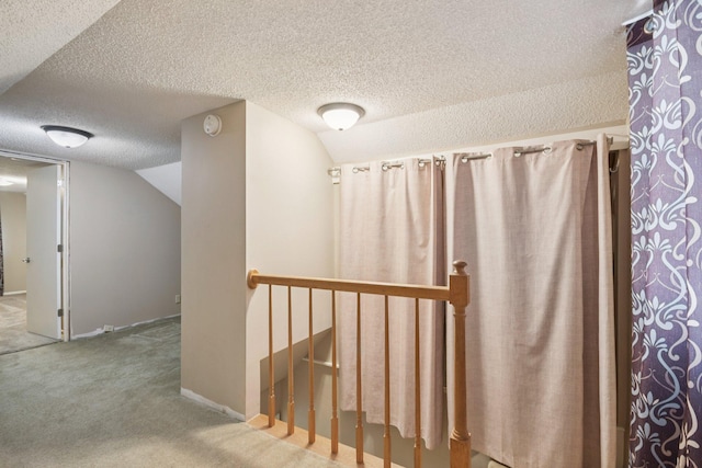 272 Butler Ave E, West Saint Paul, MN 55118 - corridor featuring lofted ceiling, a textured ceiling, an upstairs landing, and carpet