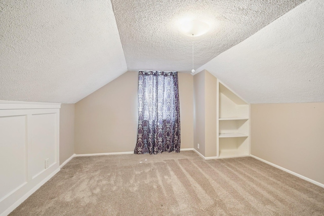 272 Butler Ave E, West Saint Paul, MN 55118 - bonus room with a textured ceiling, carpet, lofted ceiling, and built in shelves