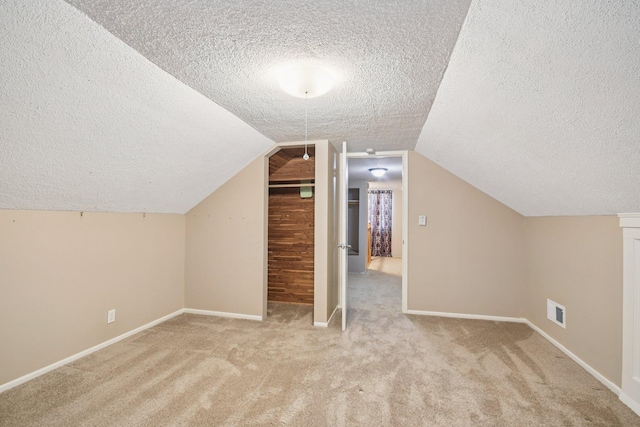 272 Butler Ave E, West Saint Paul, MN 55118 - additional living space with a textured ceiling, carpet floors, and vaulted ceiling