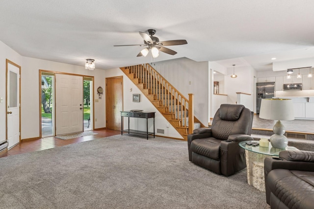 16059 Kettle River Blvd NE, Columbus, MN 55025 - carpeted living room featuring stairs and a ceiling fan