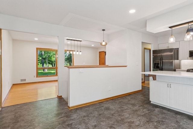 16059 Kettle River Blvd NE, Columbus, MN 55025 - kitchen with white cabinetry, stainless steel appliances, recessed lighting, light countertops, and hanging light fixtures