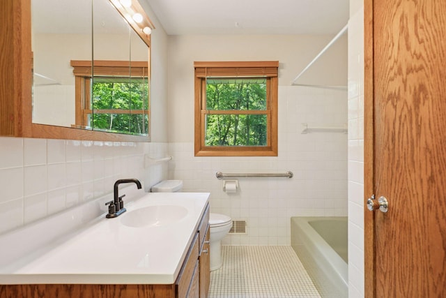16059 Kettle River Blvd NE, Columbus, MN 55025 - full bathroom featuring plenty of natural light, tile walls, vanity, tile patterned flooring, and bathing tub / shower combination