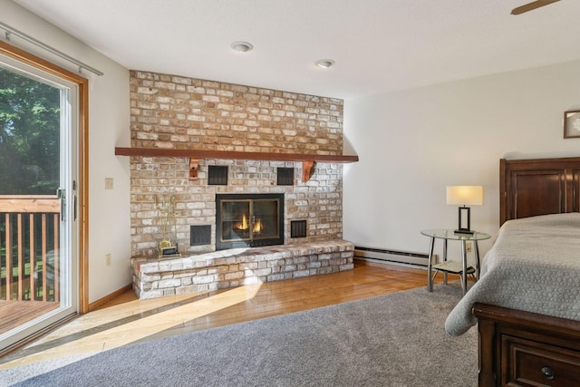 16059 Kettle River Blvd NE, Columbus, MN 55025 - bedroom with a brick fireplace, a baseboard radiator, and wood finished floors