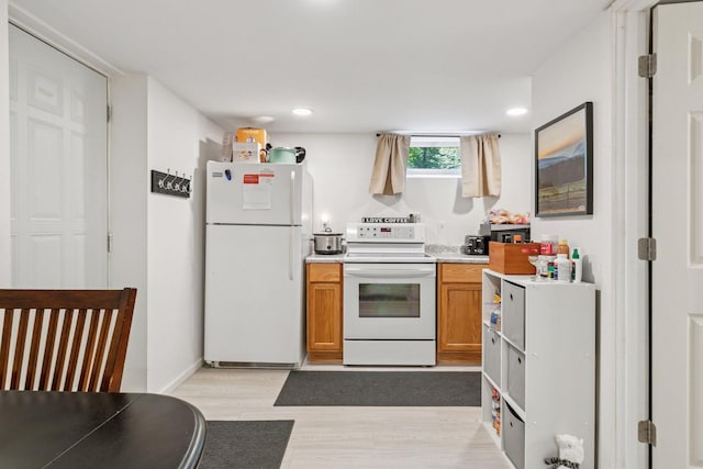 16059 Kettle River Blvd NE, Columbus, MN 55025 - kitchen featuring white appliances, light countertops, brown cabinets, light wood-type flooring, and recessed lighting