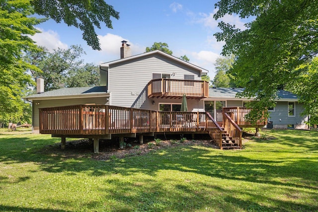 16059 Kettle River Blvd NE, Columbus, MN 55025 - rear view of house with a chimney, a wooden deck, a lawn, and roof with shingles
