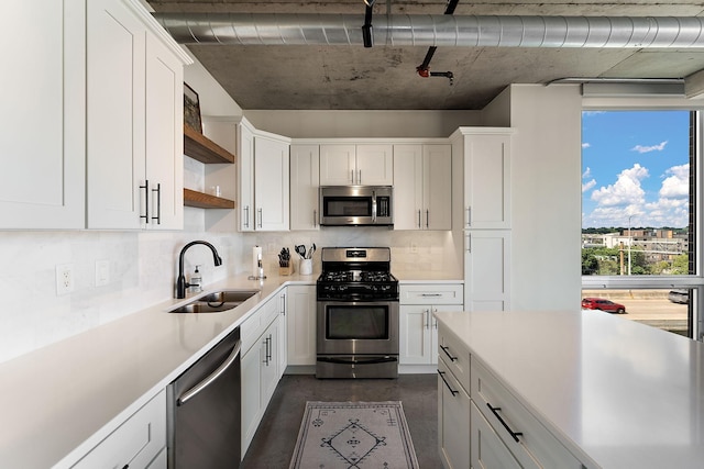 730 4th St Unit 601, Minneapolis, MN 55401 - kitchen with stainless steel appliances, open shelves, light countertops, white cabinetry, and backsplash
