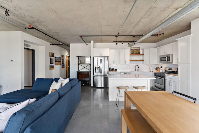 730 4th St Unit 601, Minneapolis, MN 55401 - kitchen with stainless steel appliances, open floor plan, a center island, light countertops, and white cabinets