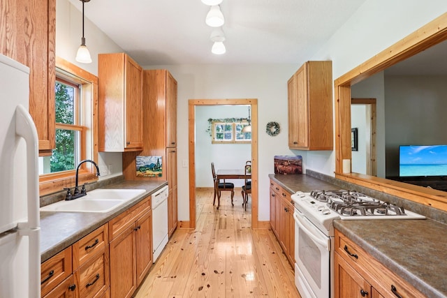31338 Oasis Rd, Center City, MN 55012 - kitchen with white appliances, dark countertops, light wood-type flooring, decorative light fixtures, and brown cabinets